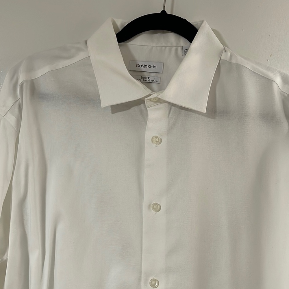 Man Dresses Shirt